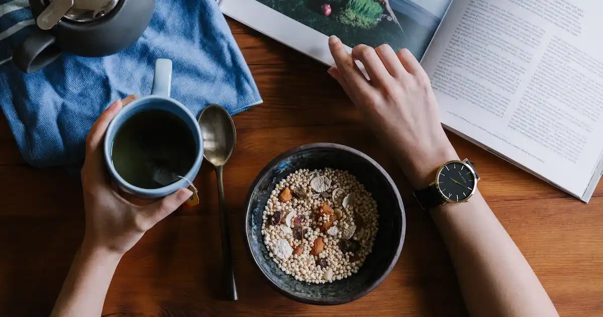 Eating a bowl of museli and reading a book