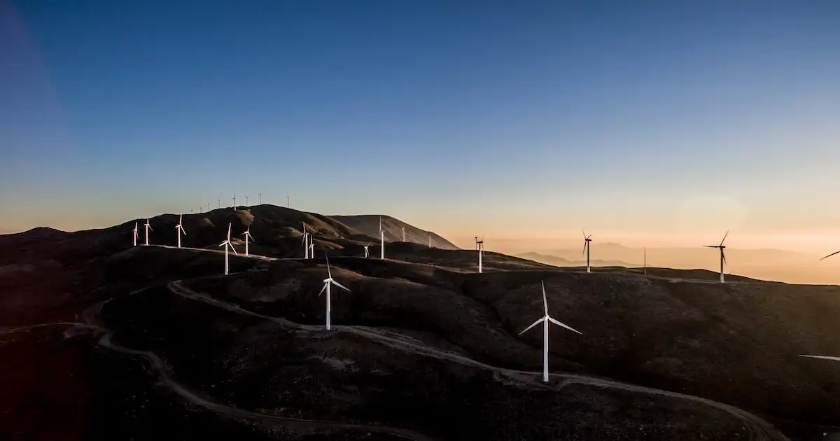 Many windmills on the top of low hills